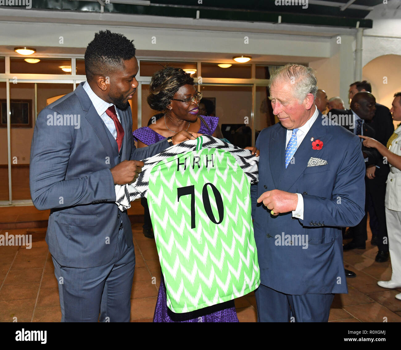 Former footballer Joseph Yobo presents The Prince of Wales with a Nigerian National football shirt as a birthday present, during a reception at The British Deputy High Commioner's Residence in Nigeria, on day eight of his trip to west Africa with the Duchess of Cornwall. Stock Photo