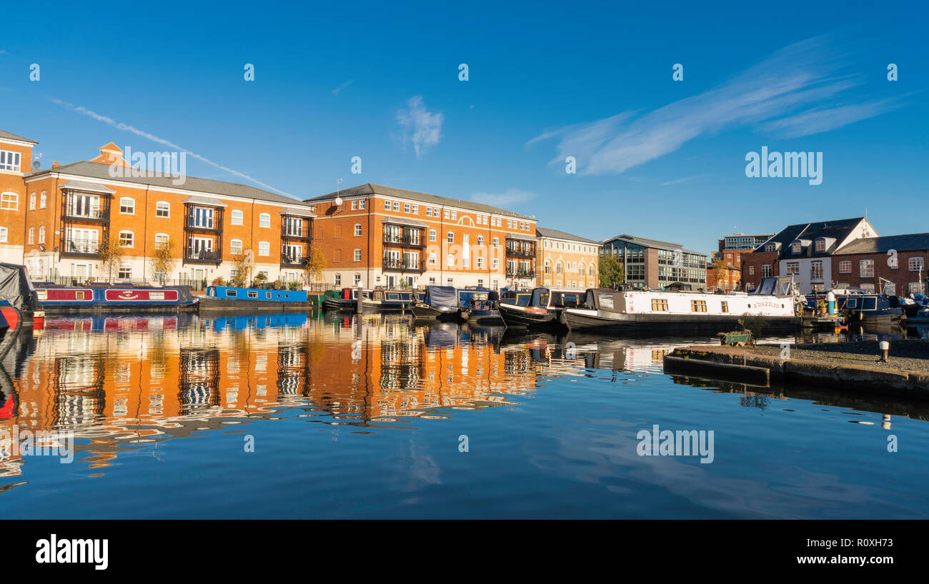 Reflections of barges and canal side buildings in the water at Diglis Basin, Worcester, UK Stock Photo