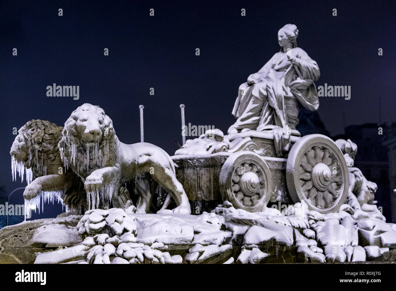 Cibeles fountain in the Plaza de Cibeles in winter with snow and icicle. The plaza is a landmark of Madrid, Spain Stock Photo