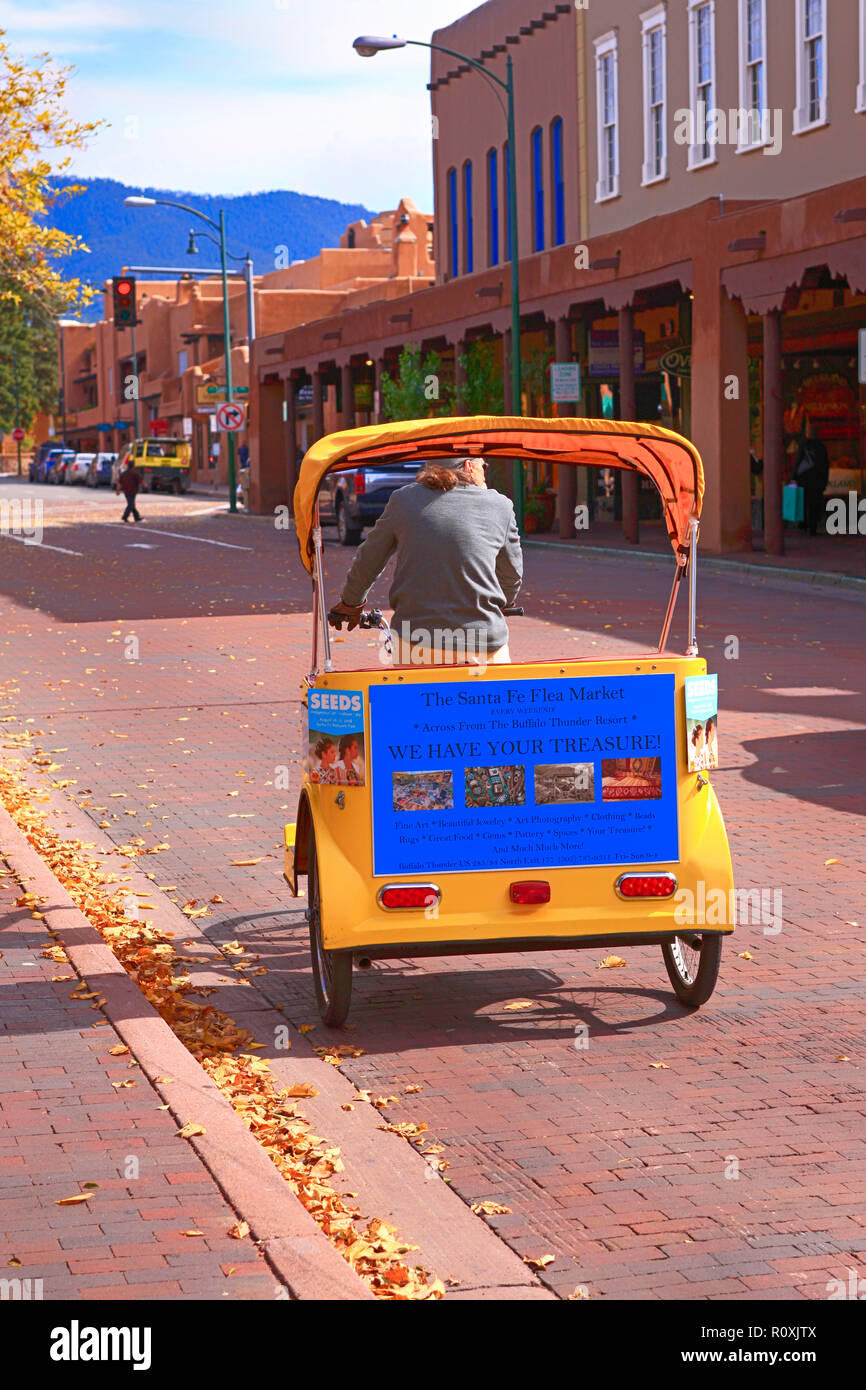 Man driving a Pedicab around the Plaza in downtown Santa Fe, New mexico