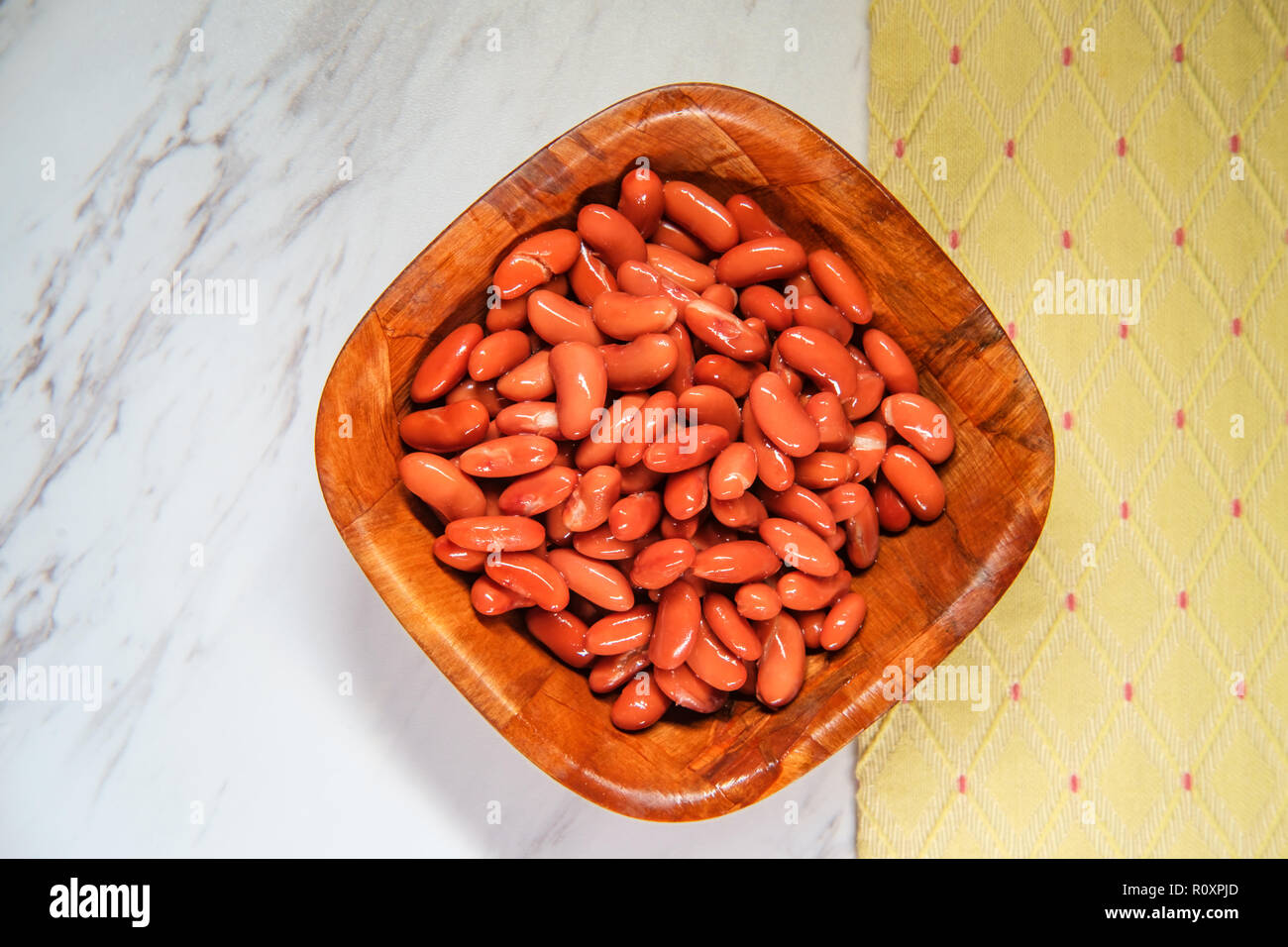 Chili ingredients wooden bowl kidney beans on marble counter Stock