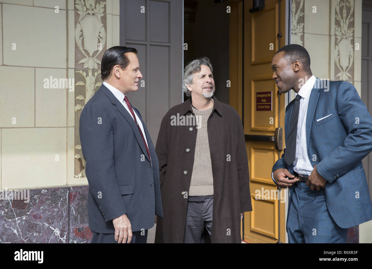 (from left) Viggo Mortensen, director Peter Farrelly, and Mahershala Ali on the set of 'Green Book.' (2018) (Credit Photo: Universal Studios / The Hollywood Archive) Stock Photo