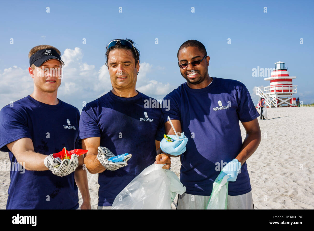Miami Beach Florida,Atlantic Ocean,water,public beach,shoreline,ECOMB Big Sweep,volunteer volunteers volunteering work worker workers,teamwork working Stock Photo