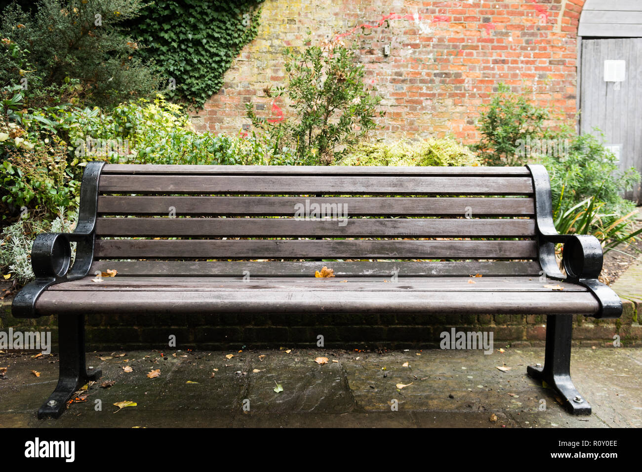 Wooden bench outside in a public area Stock Photo