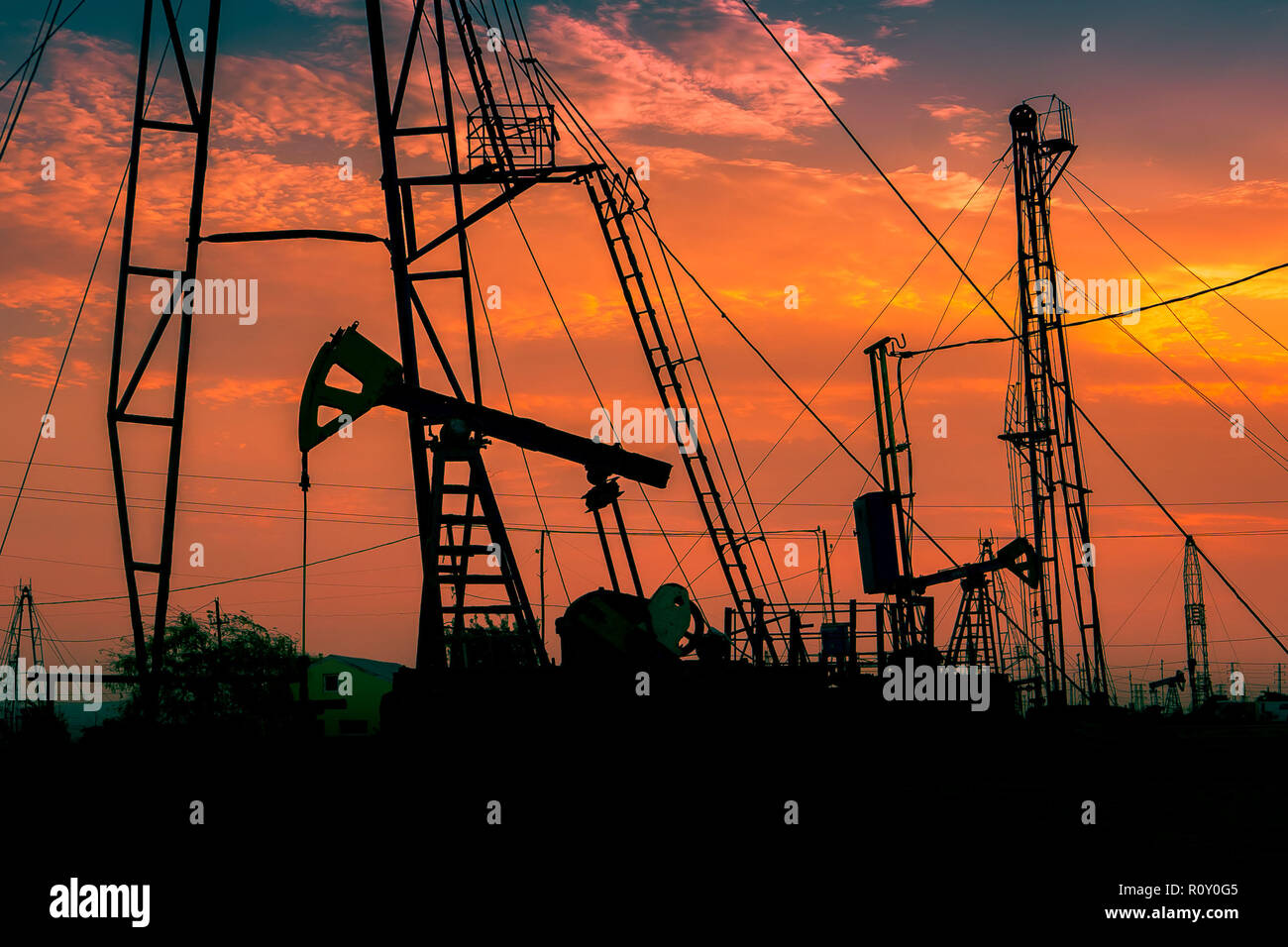 Oil rigs against beautiful sunset Stock Photo Alamy