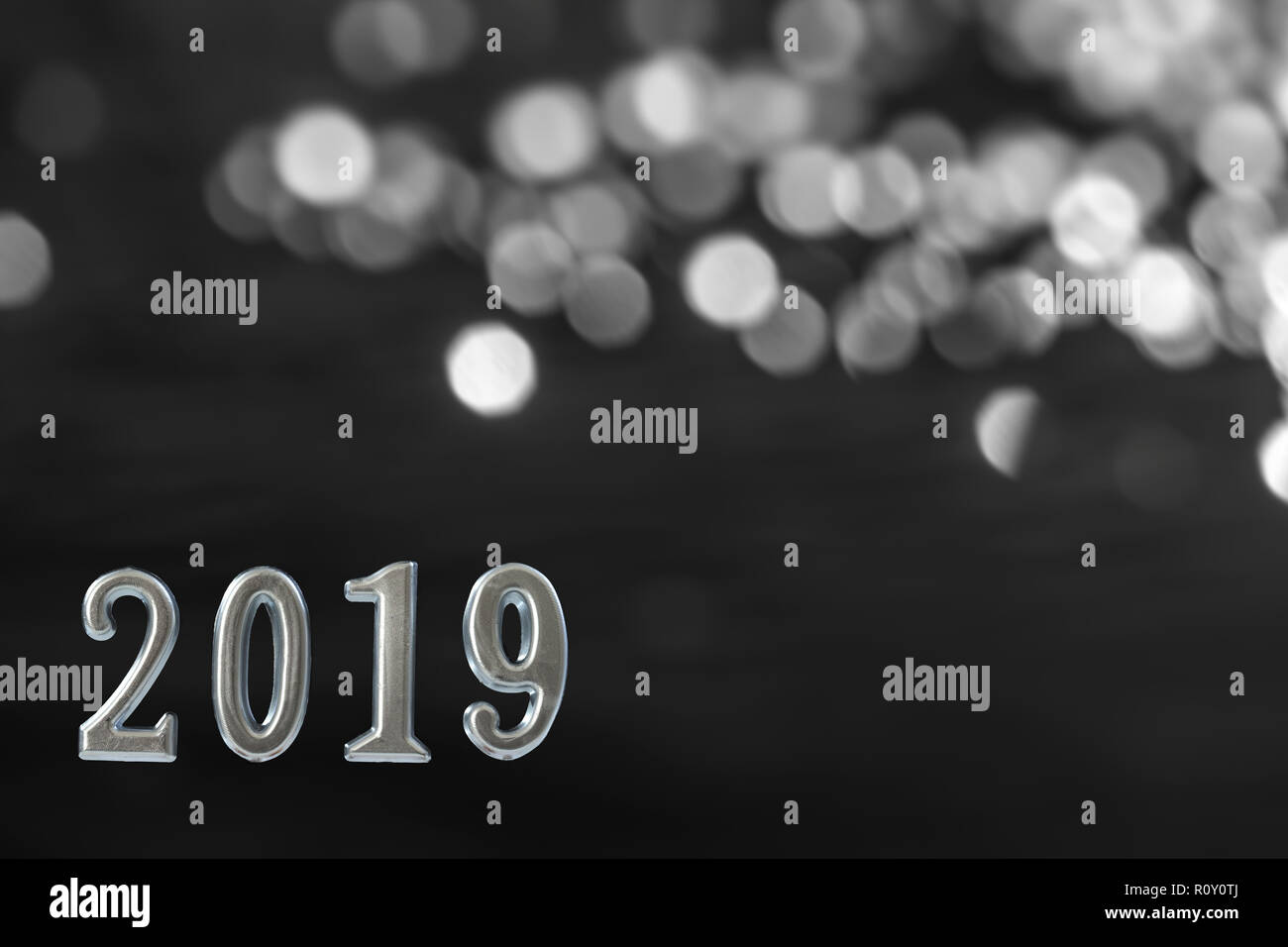 silver text of 2019 over shiny candle, on black wall.New year concept. background, Stock Photo