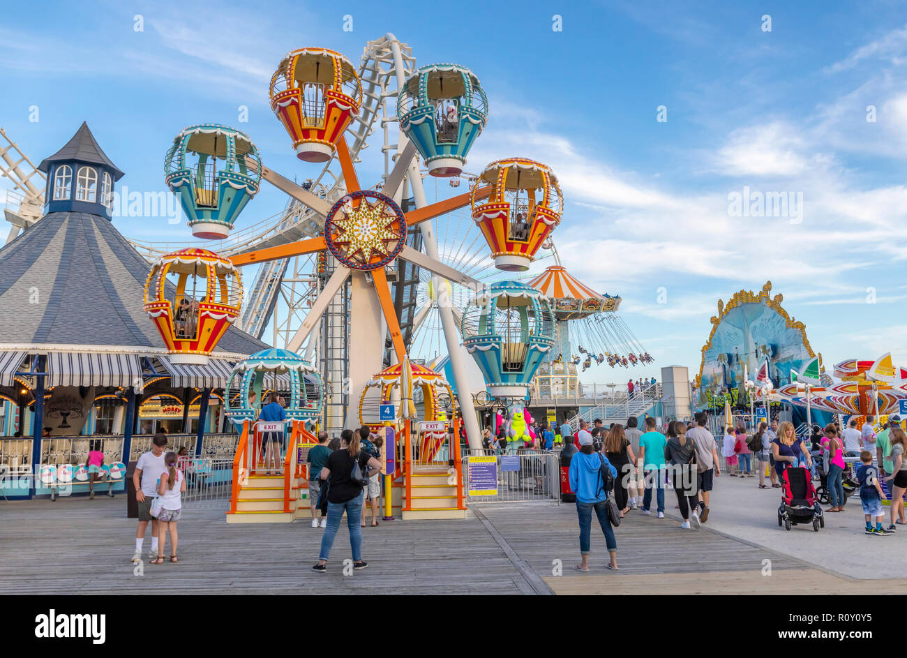 An amusement park with rides at the ocean shore. Stock Photo