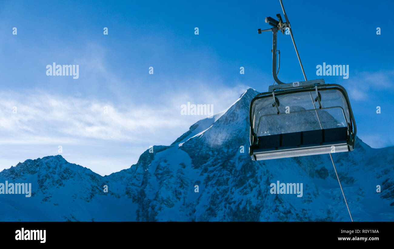 Ski Holiday - empty chairlift in high Alpine ski resort Stock Photo