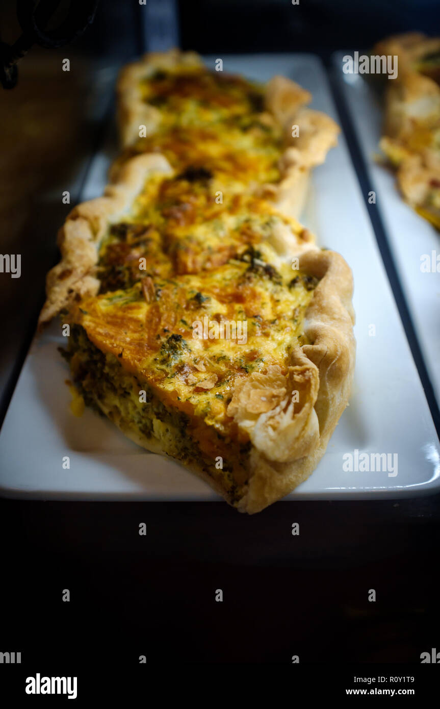 Healthy egg breakfast sliced quiche pie on display at local bakery