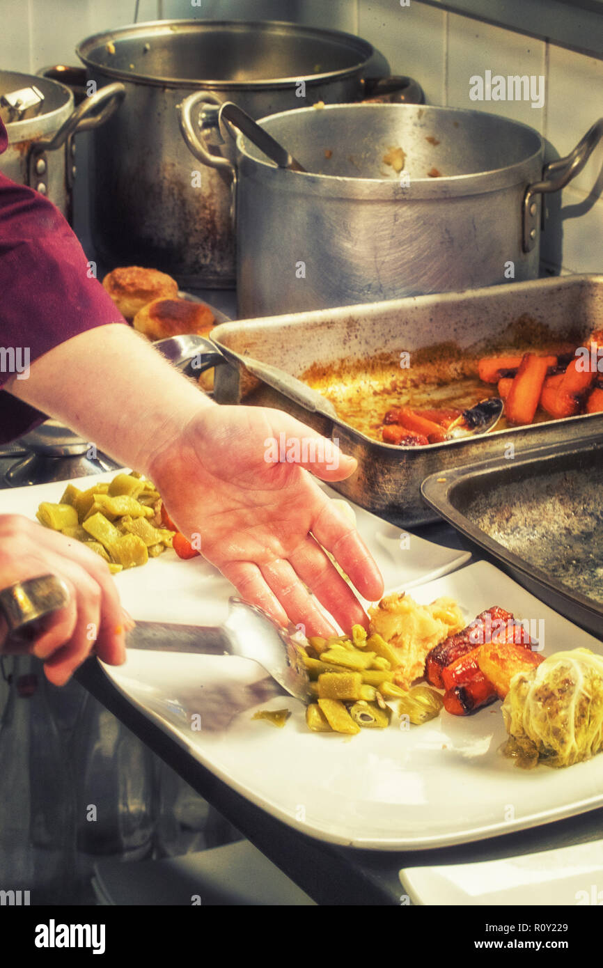 Sunday roast beef with all the trimmings being prepared and served in a