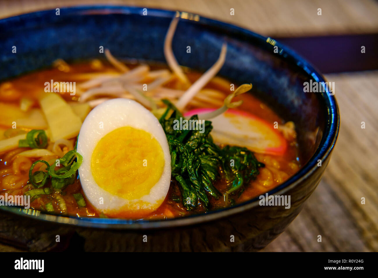Fresh spicy korean ramen with bean sprouts hard boiled egg and spinach