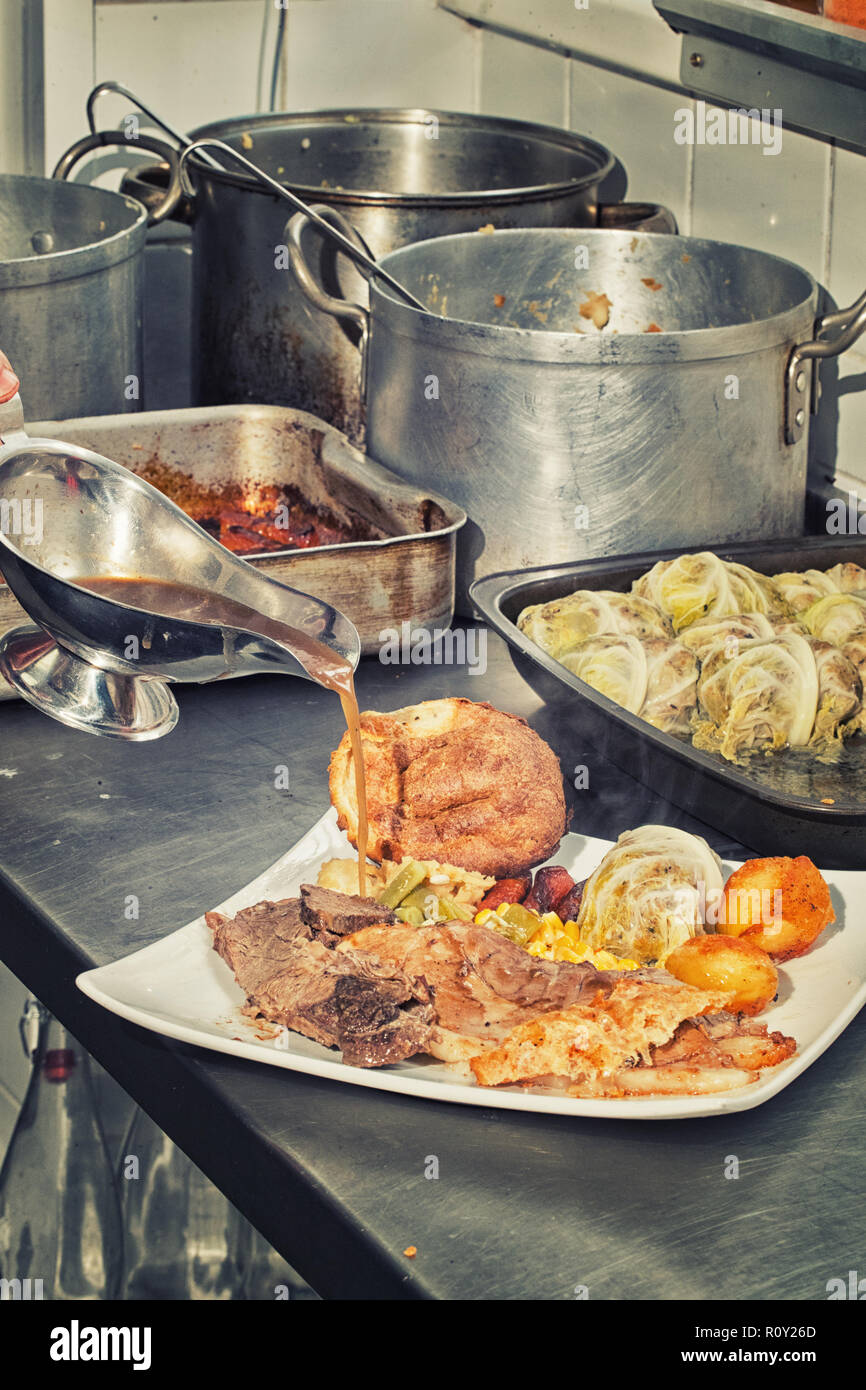 Sunday roast beef with all the trimmings being prepared and served in a