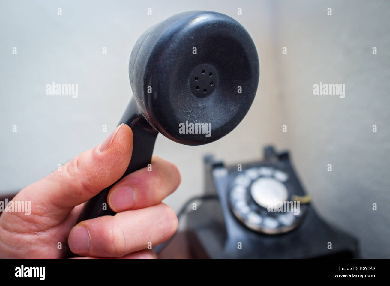 Old vintage rotary dial telephone on wooden desk Stock Photo