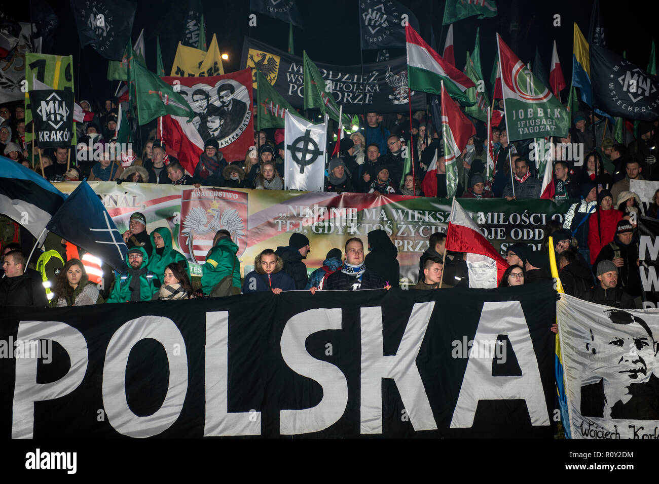 Polish and Hungarian nationalists seen with the White Power placard on the Independence Day during the protest. Last year about 60,000 people took part in the nationalist march marking Poland’s Independence Day, according to police figures. The march has taken place each year on November 11th for almost a decade, and has grown to draw tens of thousands of participants, including extremists from across the EU. Warsaw’s mayor Hanna Gronkiewicz-Waltz has banned the event. Organizers said they would appeal against the decision, insisting they would go ahead with the march anyway and raising the pr Stock Photo