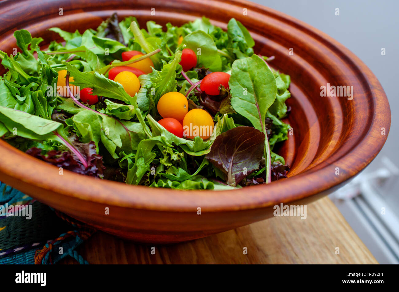 Fresh organic spring mix salad with red and yellow grape tomatoes Stock Photo