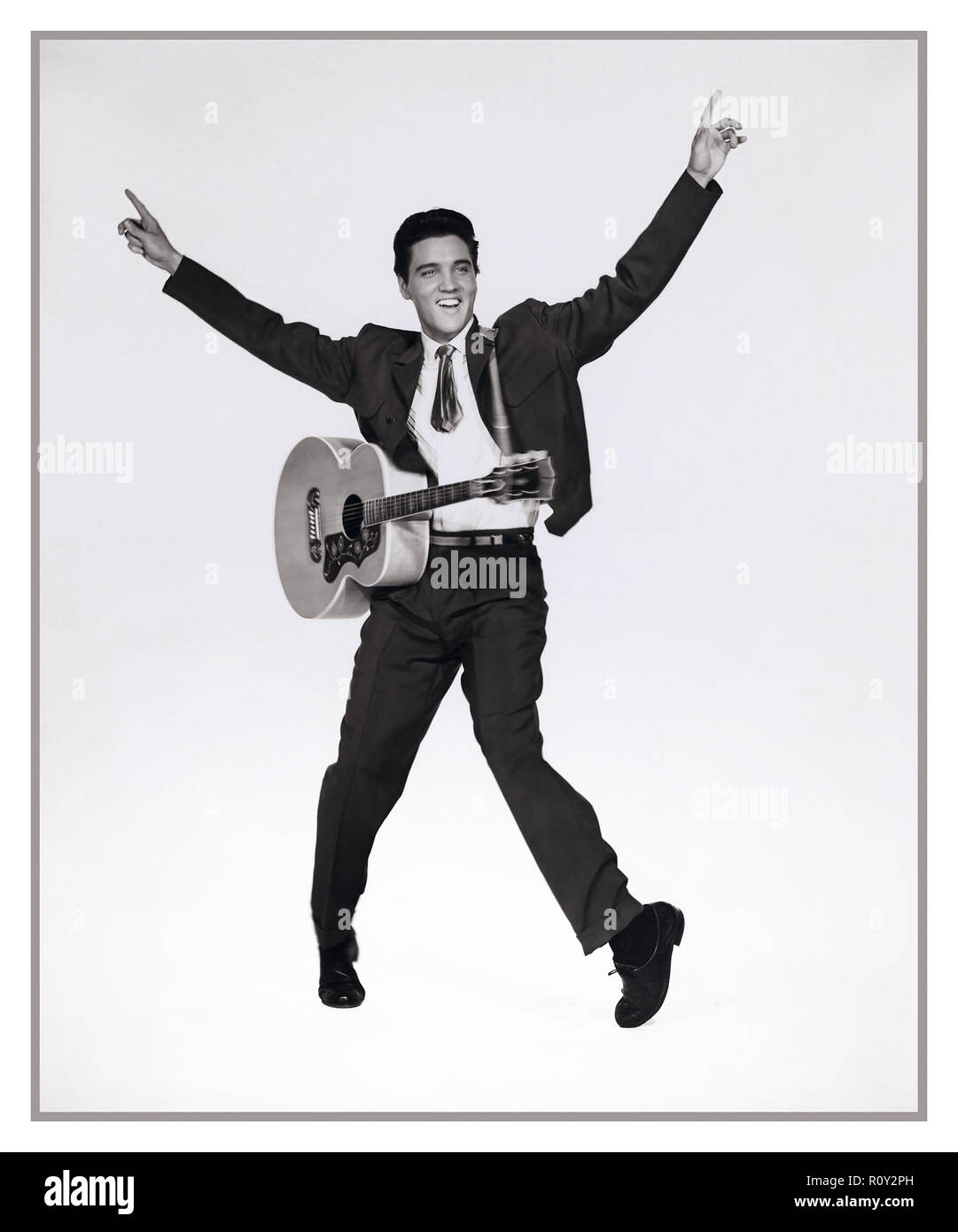 ELVIS PRESLEY with guitar, film still from King Creole 1958 (A rebellious young man takes a job as a nightclub singer to make ends meet, attracting the attention of a local crime boss etc...) Stock Photo