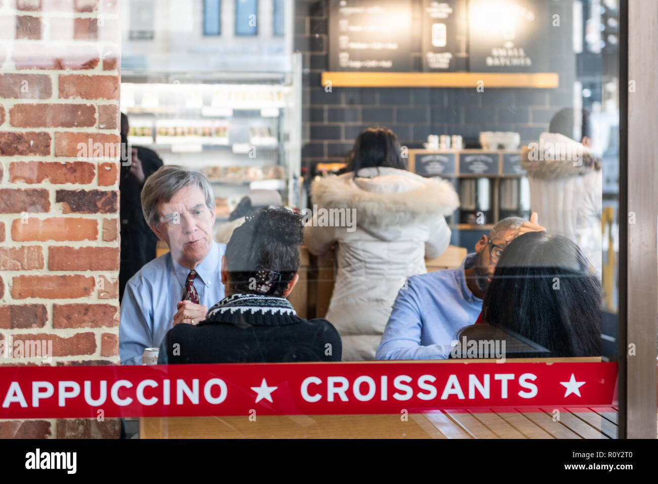 Washington DC, USA - March 9, 2018: Pret a Manger sandwich store, shop, cafe window, see through, reflection, people, woman, man sitting by table eati Stock Photo