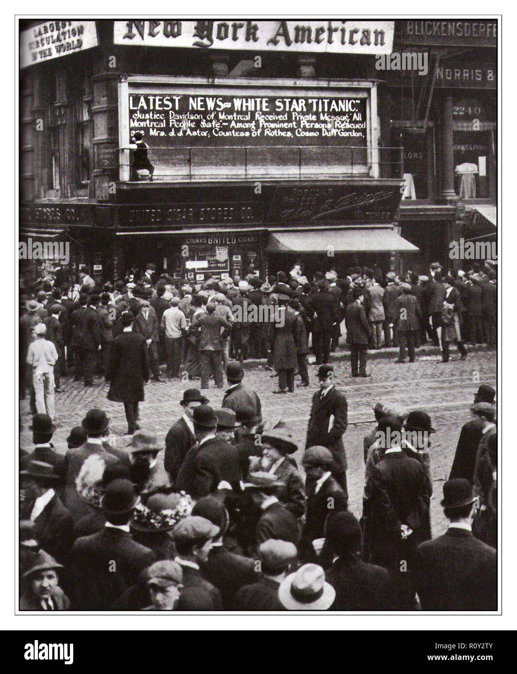TITANIC NEWS REPORTS TIMES SQUARE New York USA  Reports of  'Titanic' sinking arrive in New York, USA, April 1912. As latest news bulletins of disaster arrived, crowds formed in Times Square New York to read the updating newspaper bulletin boards. Operated by the White Star Line, RMS 'Titanic' struck an iceberg in thick fog off Newfoundland on 14 April 1912. She was the largest ocean liner of her time, and said to be unsinkable. Stock Photo