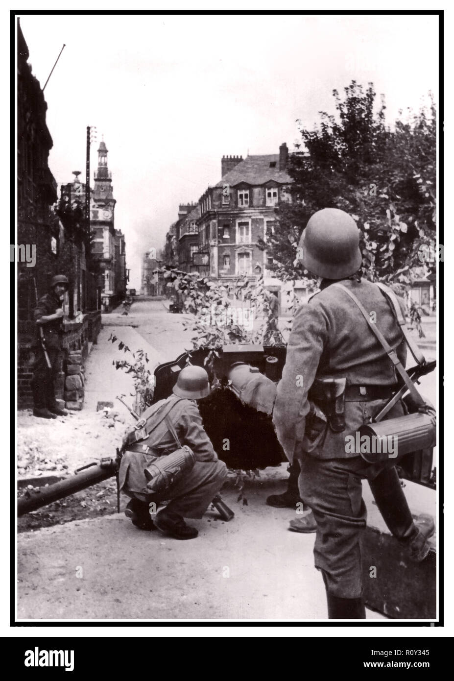 WW2 Dieppe street fighting Vintage Nazi Wehrmacht  Army with distinct  Stahlhelm helmets during raid on Dieppe WW2 image Wehrmacht raid Dieppe Northern France 1942 Stock Photo