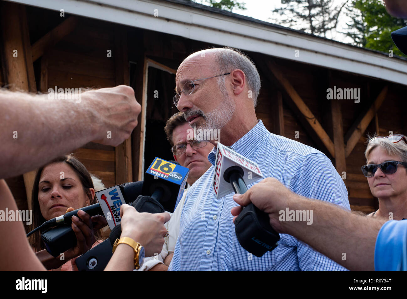 Pennsylvania Governor Tom Wolf talks to local and state representatives in August 2018 after flash flooding there destroyed area homes and businesses. Stock Photo