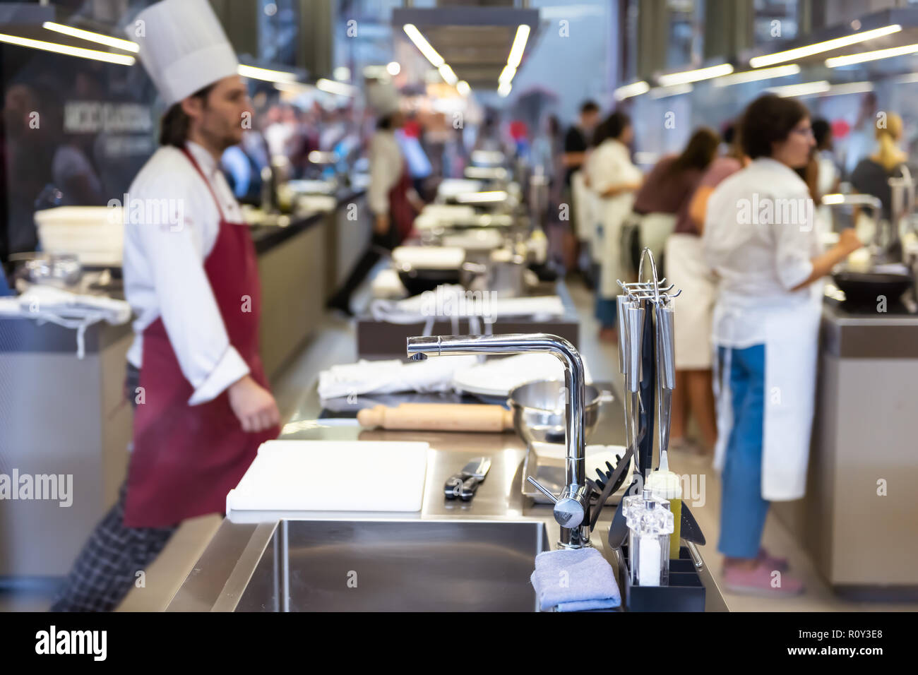 Florence, Italy - August 30, 2018: Kitchen of restaurants, cafes in Firenze Centrale Mercato, central market with cooks, chefs walking, stainless stee Stock Photo