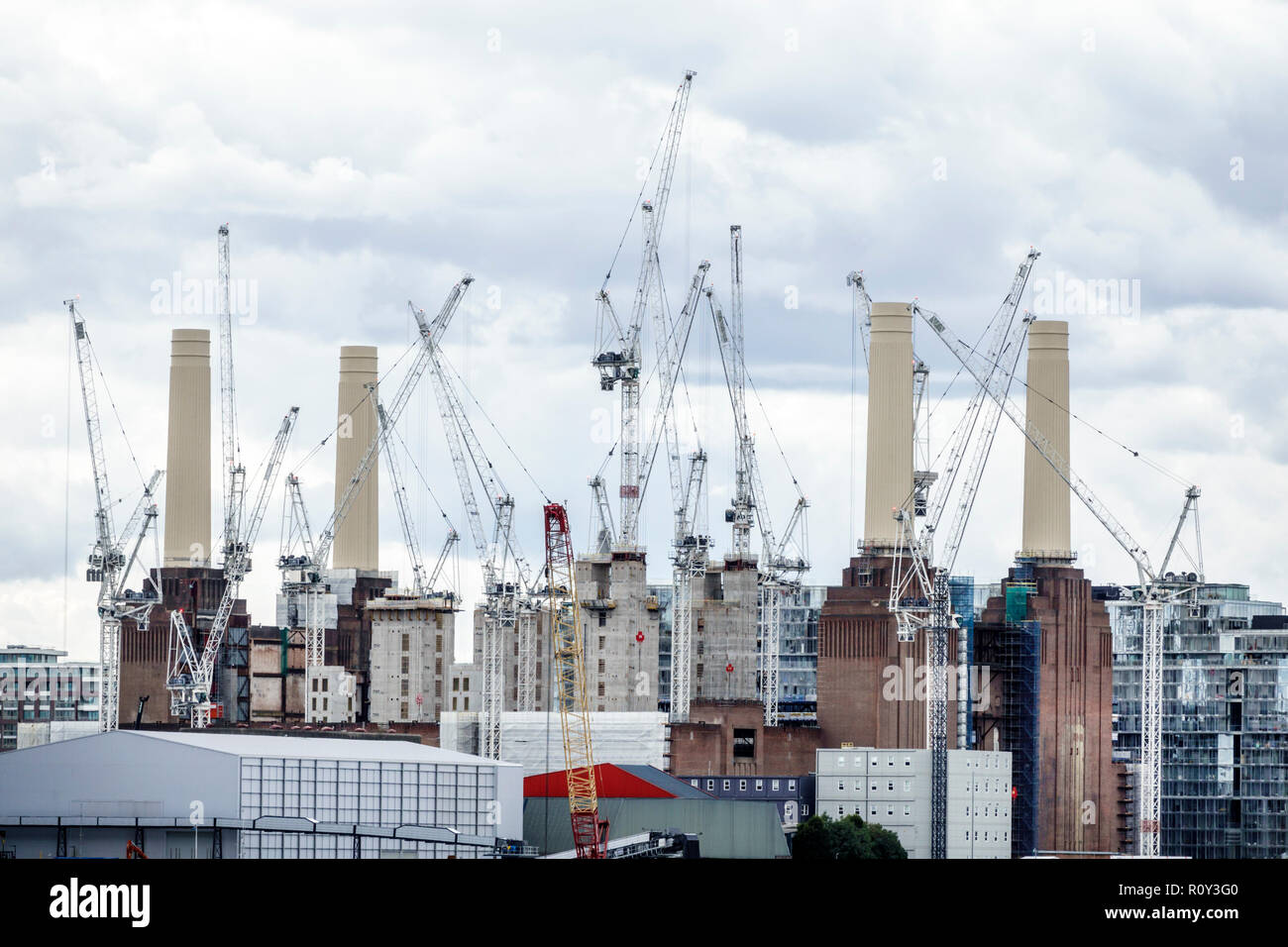 London England,UK,Battersea Power Station Estates,repurpose abandoned industrial site,redevelopment revitalization,chimneys,construction cranes,land u Stock Photo