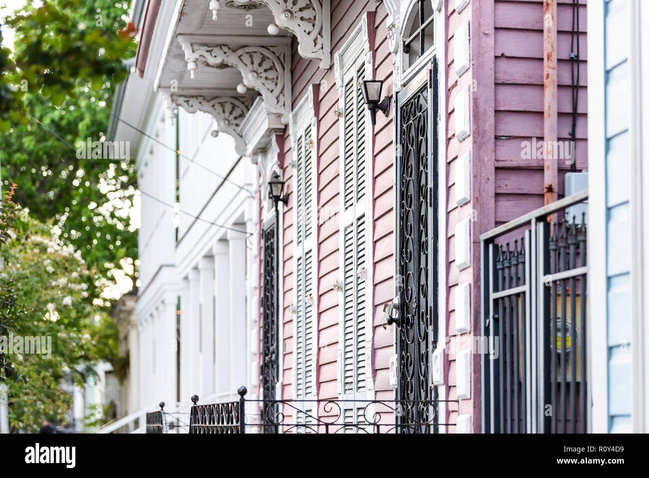 New Orleans, USA Old street historic district in Louisiana famous town, city, pink painted house wall colorful entrance, building nobody on sidewalk Stock Photo