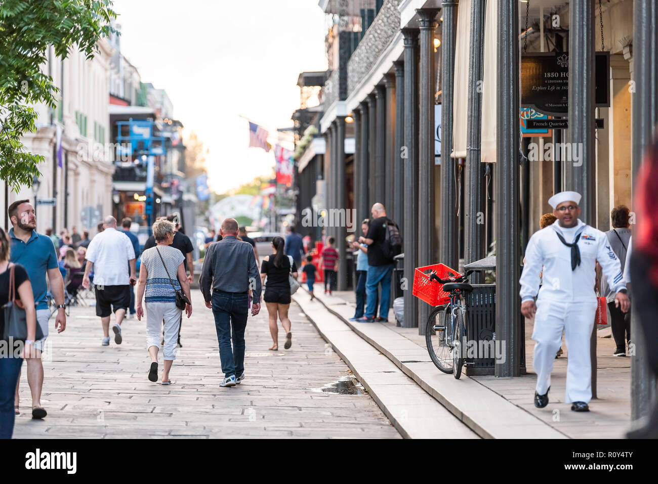 New Orleans, USA - April 22, 2018: Downtown old town St Ann street in Louisiana famous town, city with people walking in evening Stock Photo