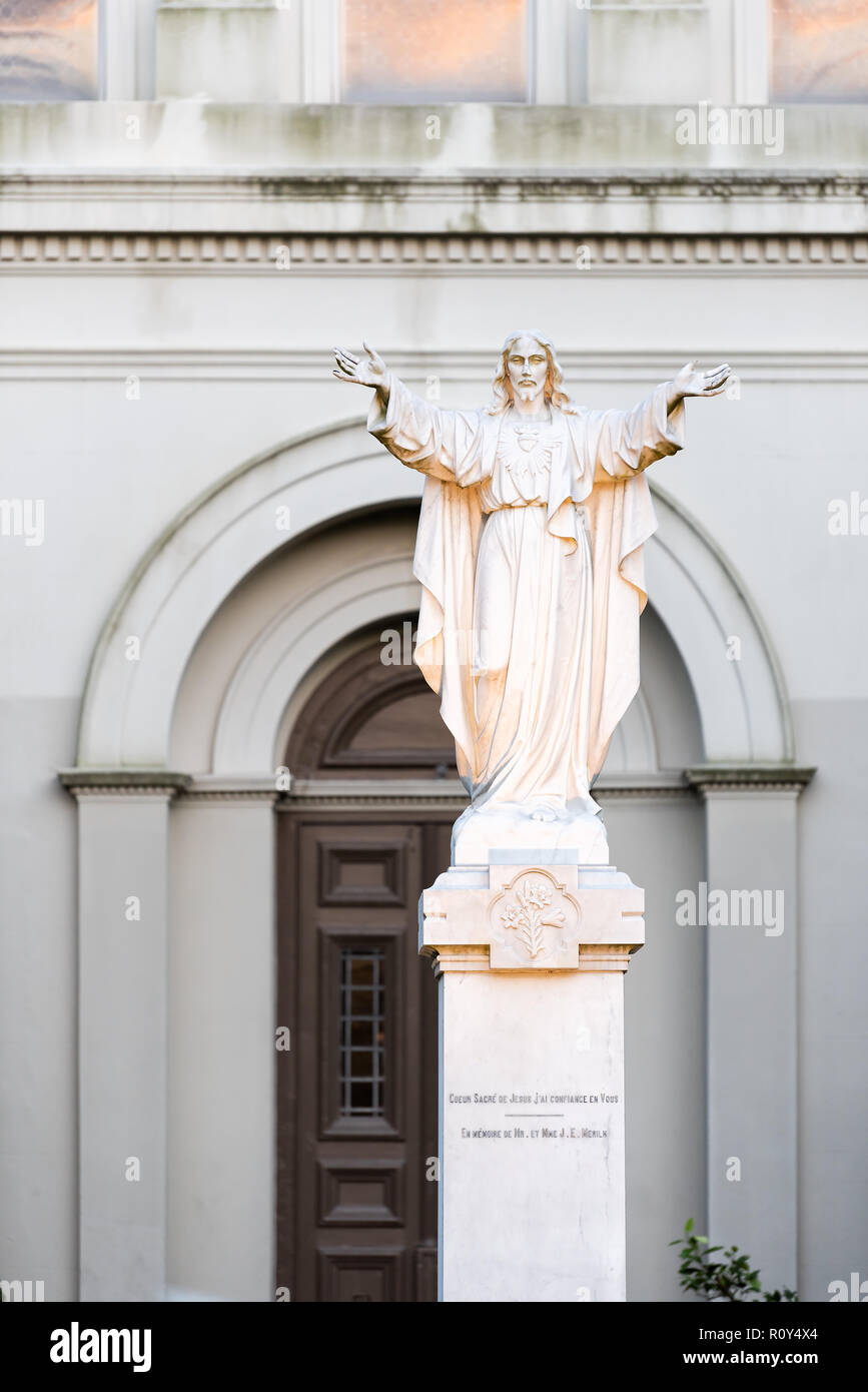 New Orleans, USA - April 22, 2018: St Anthony's garden on Royal street in Louisiana famous town, city with closeup of Jesus Christ statue in St Louis Stock Photo