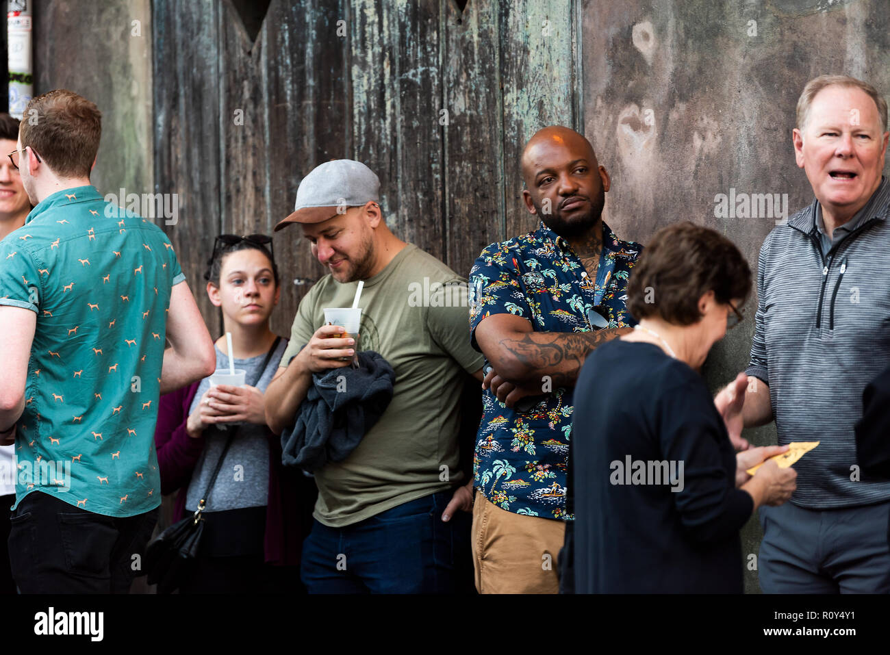 New Orleans, USA - April 22, 2018: People happy standing in line queue waiting for Preservation Hall in old town dark night St Peter Pierre street in  Stock Photo