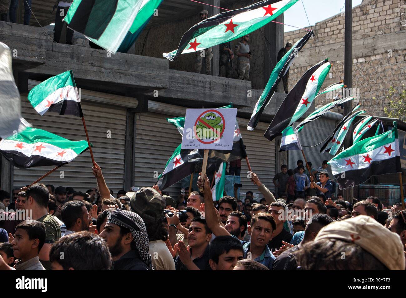 Albab, Syrian north, Syria. 28th Sep, 2018. A crowd of people seen holding Syrian flags during the demonstration.Continued demonstrations by the Syrian people against the Assad regime. Credit: Ahmad Al-Islam/SOPA Images/ZUMA Wire/Alamy Live News Stock Photo