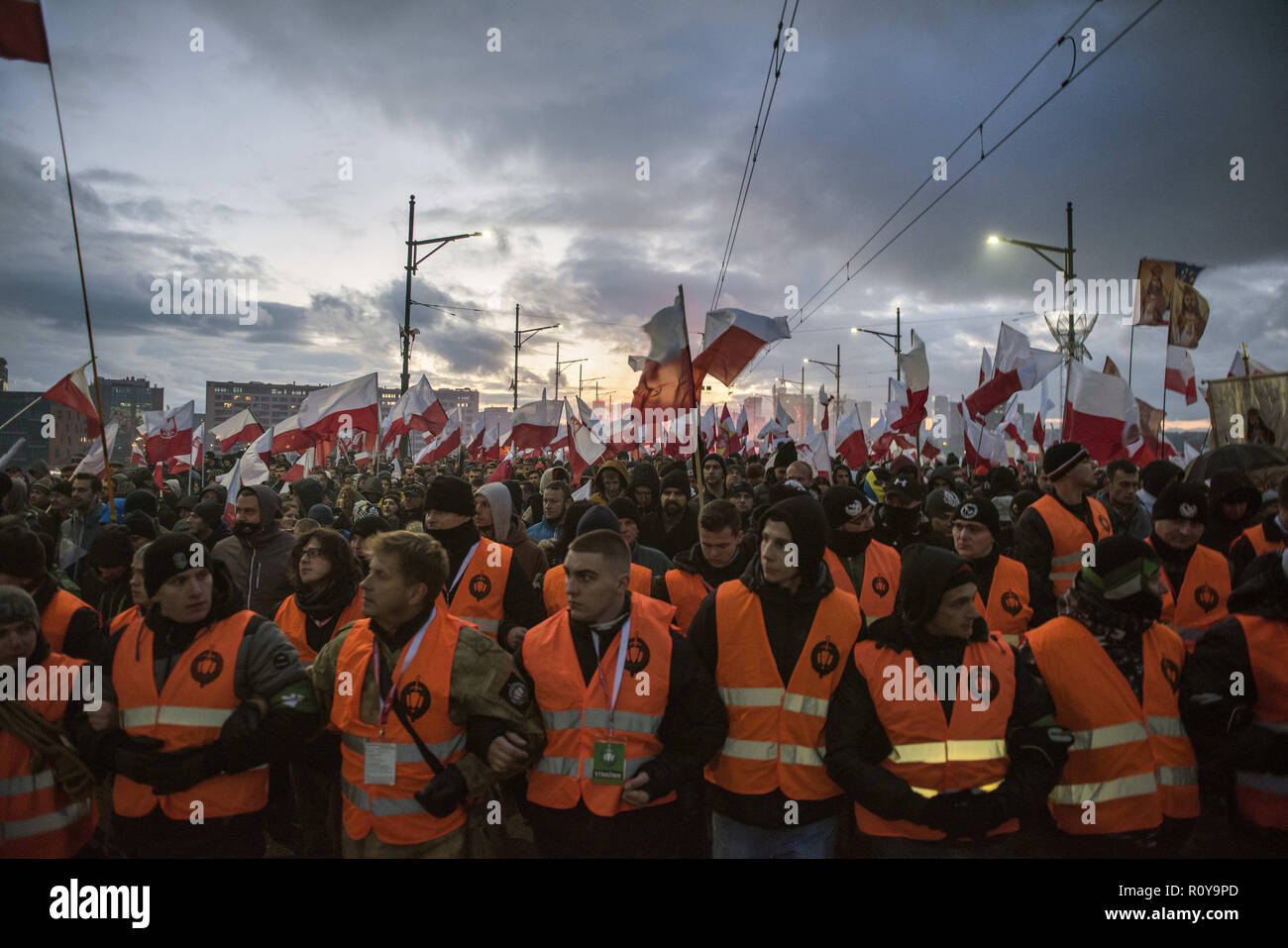 November 11, 2017 - Warsaw, mazowieckie, Poland - Huge crowds seen marching in the streets with reflector jackets during the demonstration.Last year about 60,000 people took part in the nationalist march marking Poland's Independence Day, according to police figures. The march has taken place each year on November 11th for almost a decade, and has grown to draw tens of thousands of participants, including extremists from across the EU.Warsaw's mayor Hanna Gronkiewicz-Waltz has banned the event. Organizers said they would appeal against the decision, insisting they would go ahead with the Stock Photo