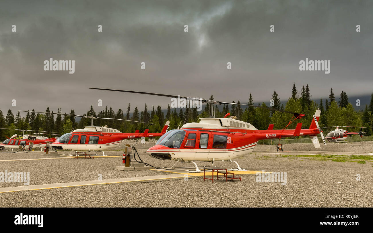 CANMORE, ALBERTA, CANADA - JUNE 2018: Bell 206 Longranger helicopters lined up at the base of Alpine Helicopters in Canmore. Stock Photo
