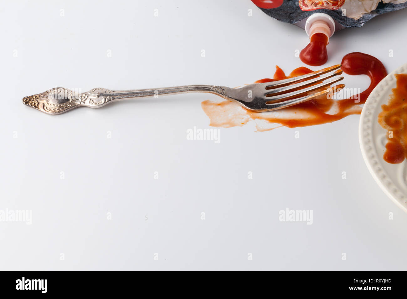 tomato sauce splashes on white backgrounds with fork Stock Photo