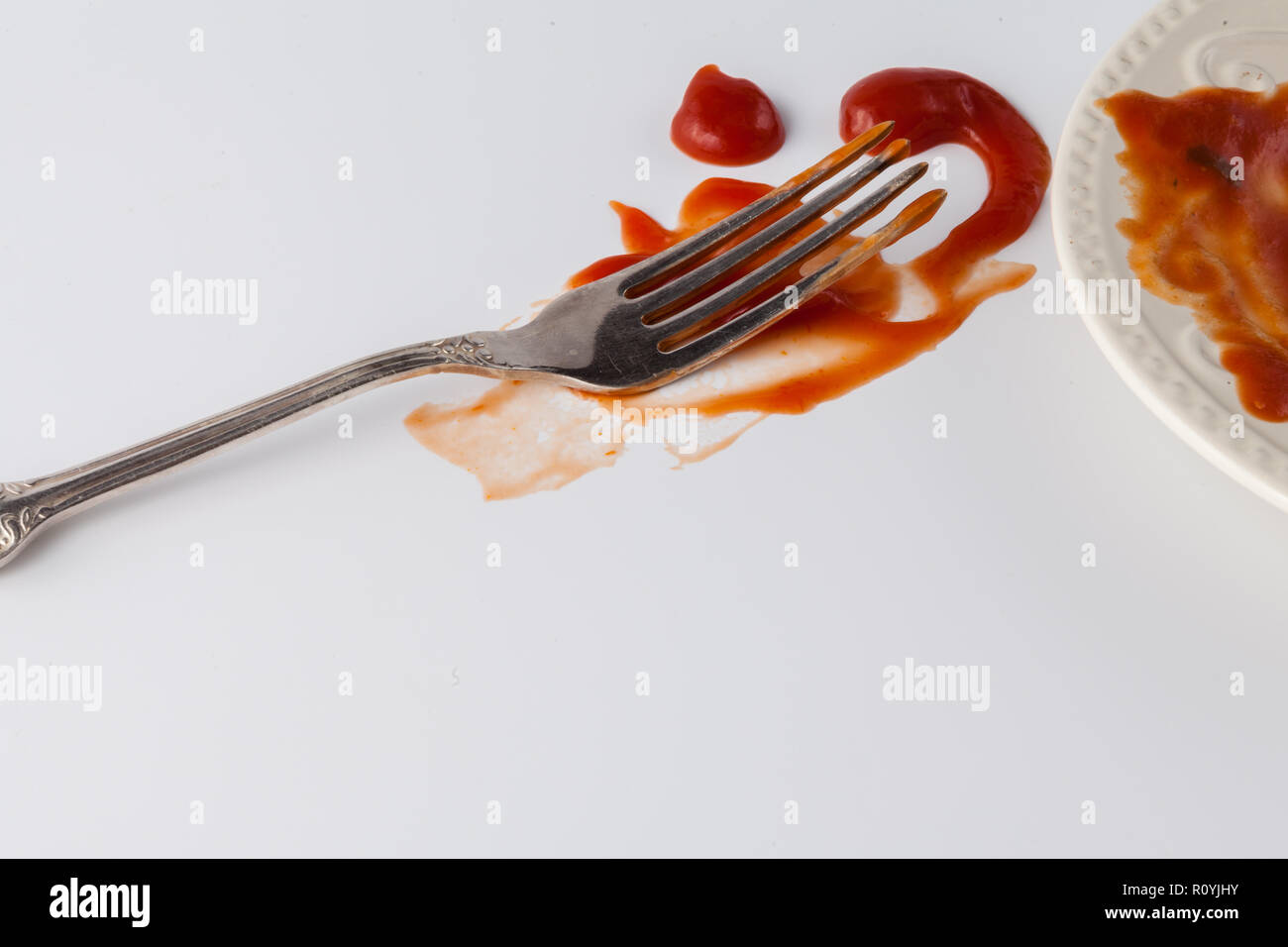 tomato sauce splashes on white backgrounds with fork Stock Photo