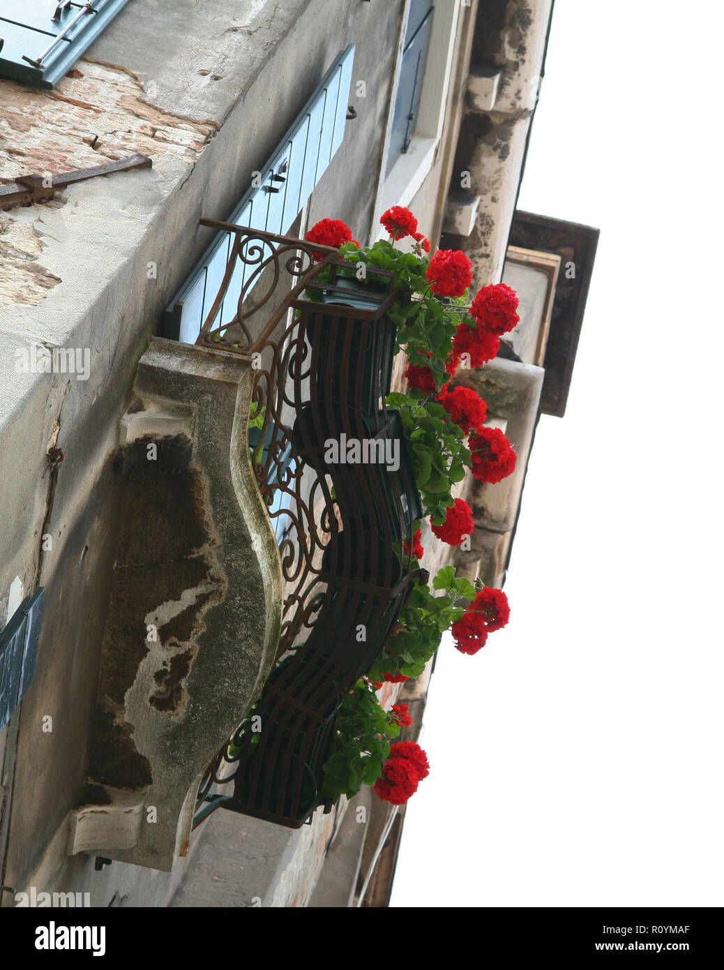 Venice, balcony with red flowers and iron railing Stock Photo - Alamy