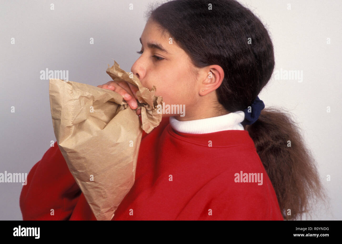 asthmatic young girl blowing into brown paper bag Stock Photo Alamy