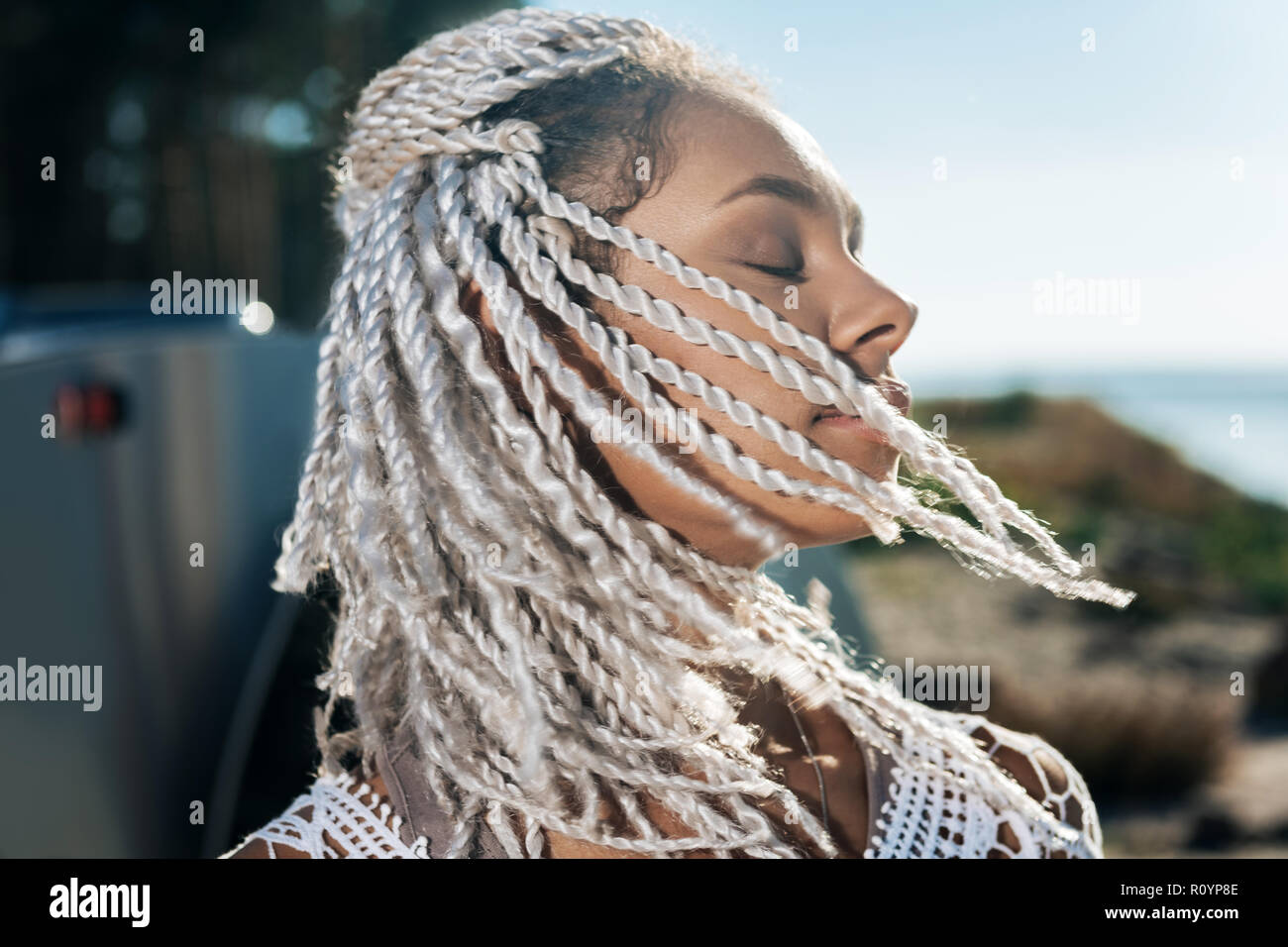 African-American woman with dreadlocks feeling relaxed while having rest Stock Photo