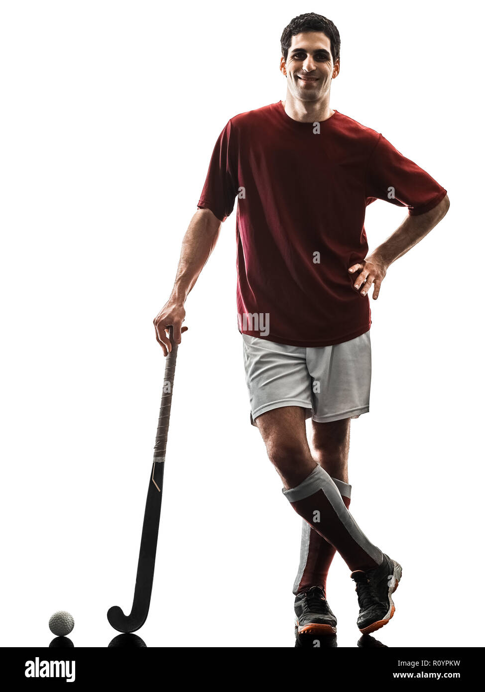 one caucasian field hockey player man isolated silhouette on white background Stock Photo