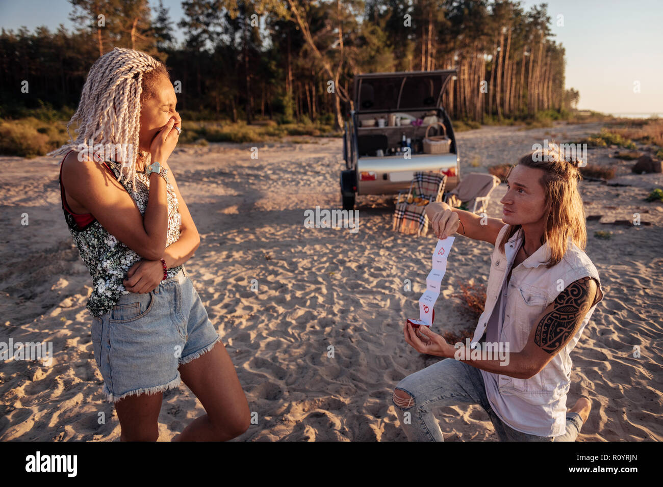 Woman with dreadlocks feeling sentimental listening to love confession Stock Photo