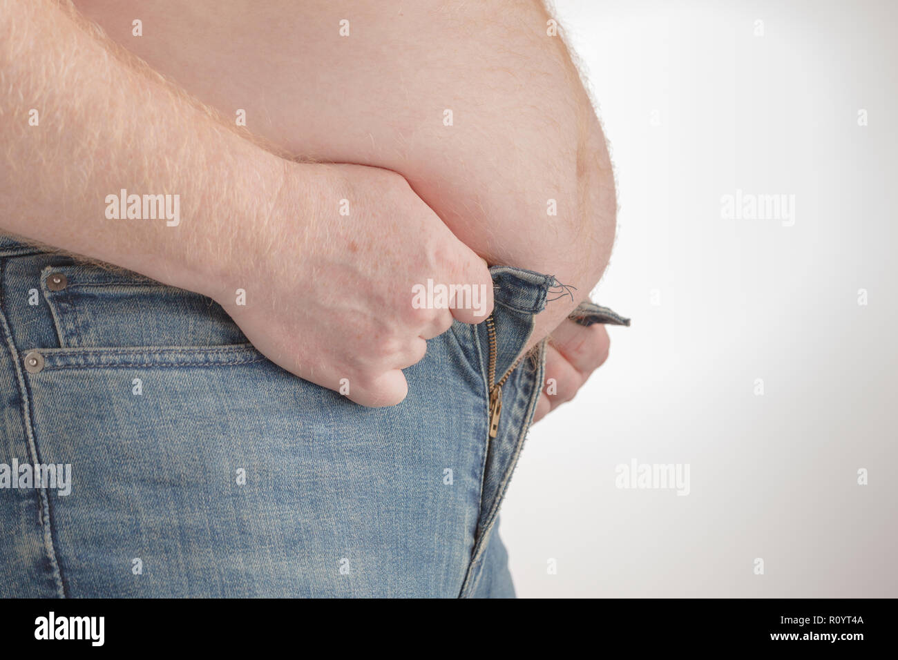 https://c8.alamy.com/comp/R0YT4A/fat-man-trying-to-put-on-pants-big-paunch-R0YT4A.jpg
