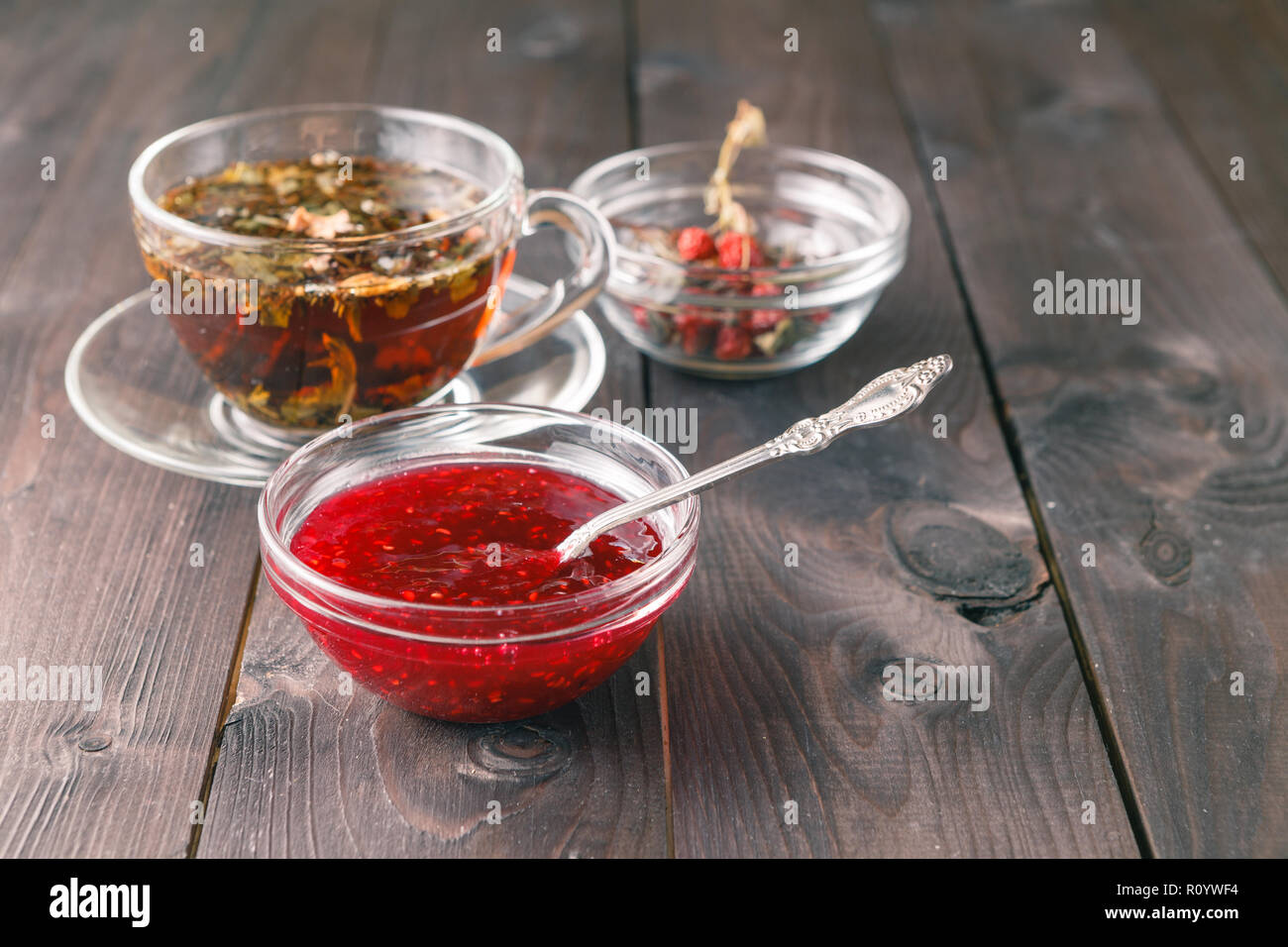 raspberry jam on table with cup of herbal tea Stock Photo - Alamy