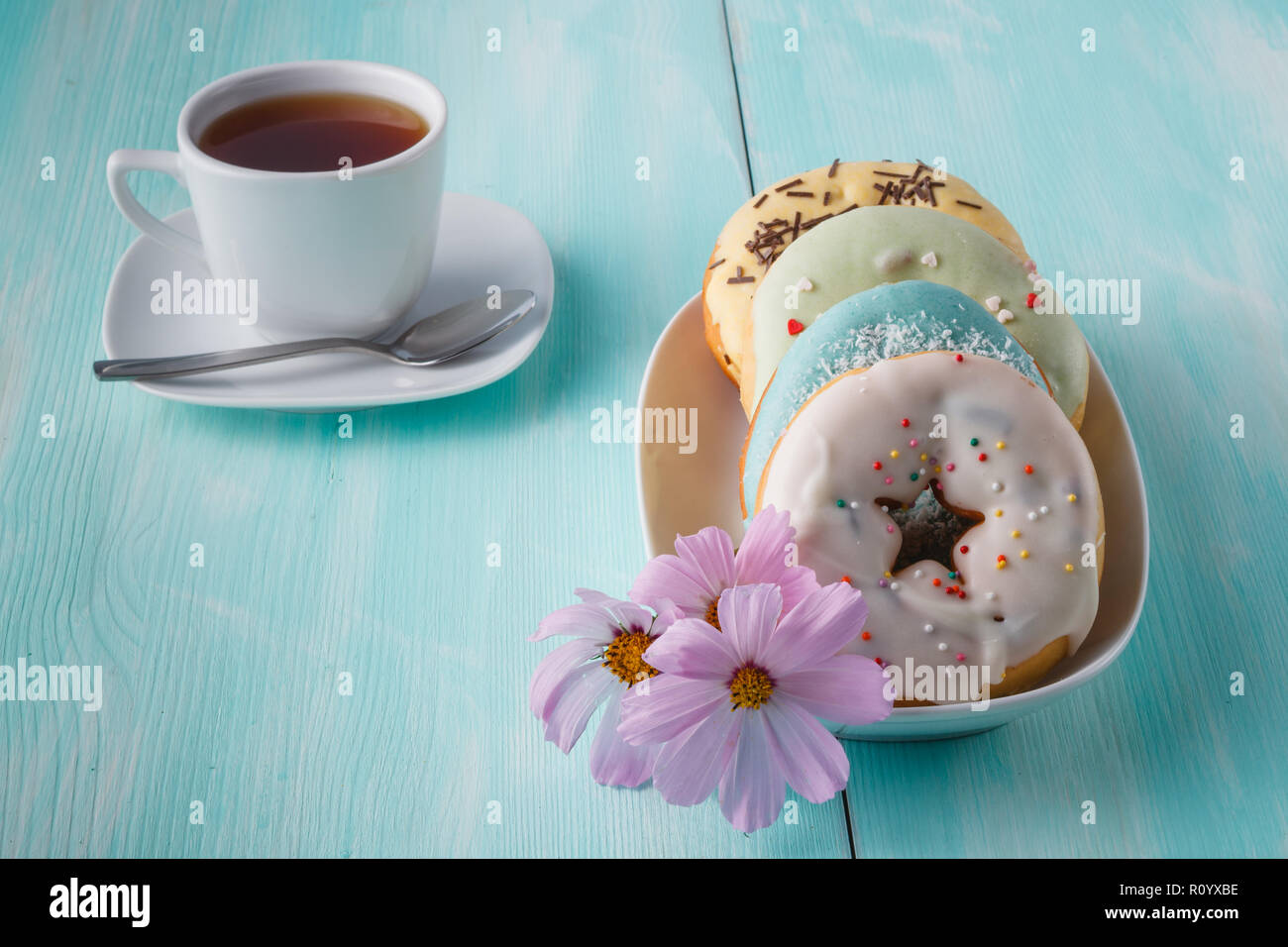 Four donuts on old wood table Stock Photo