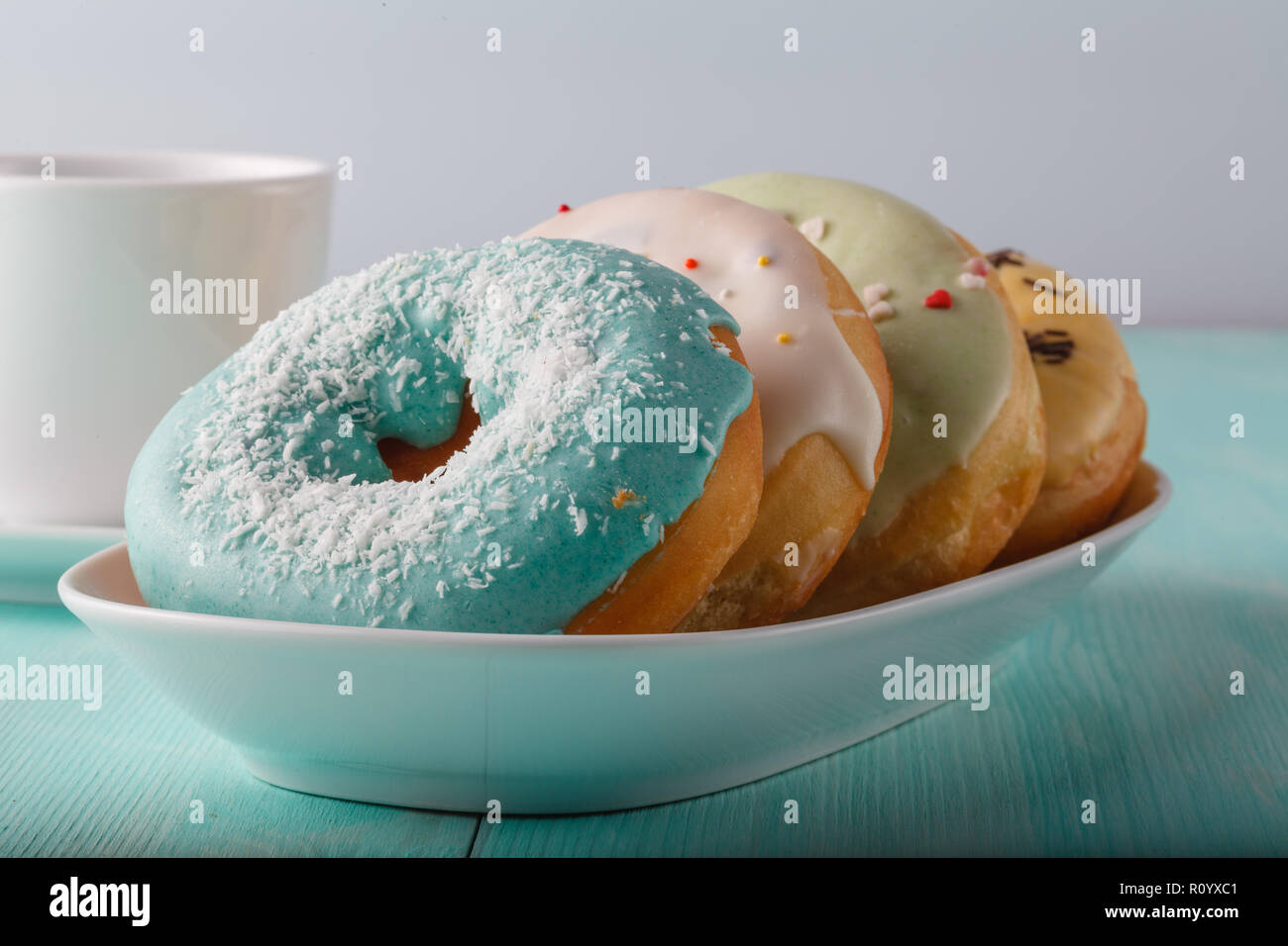 Four donuts on old wood table Stock Photo