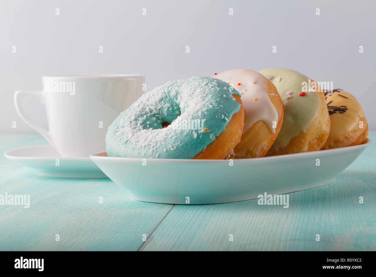 Four donuts on old wood table Stock Photo