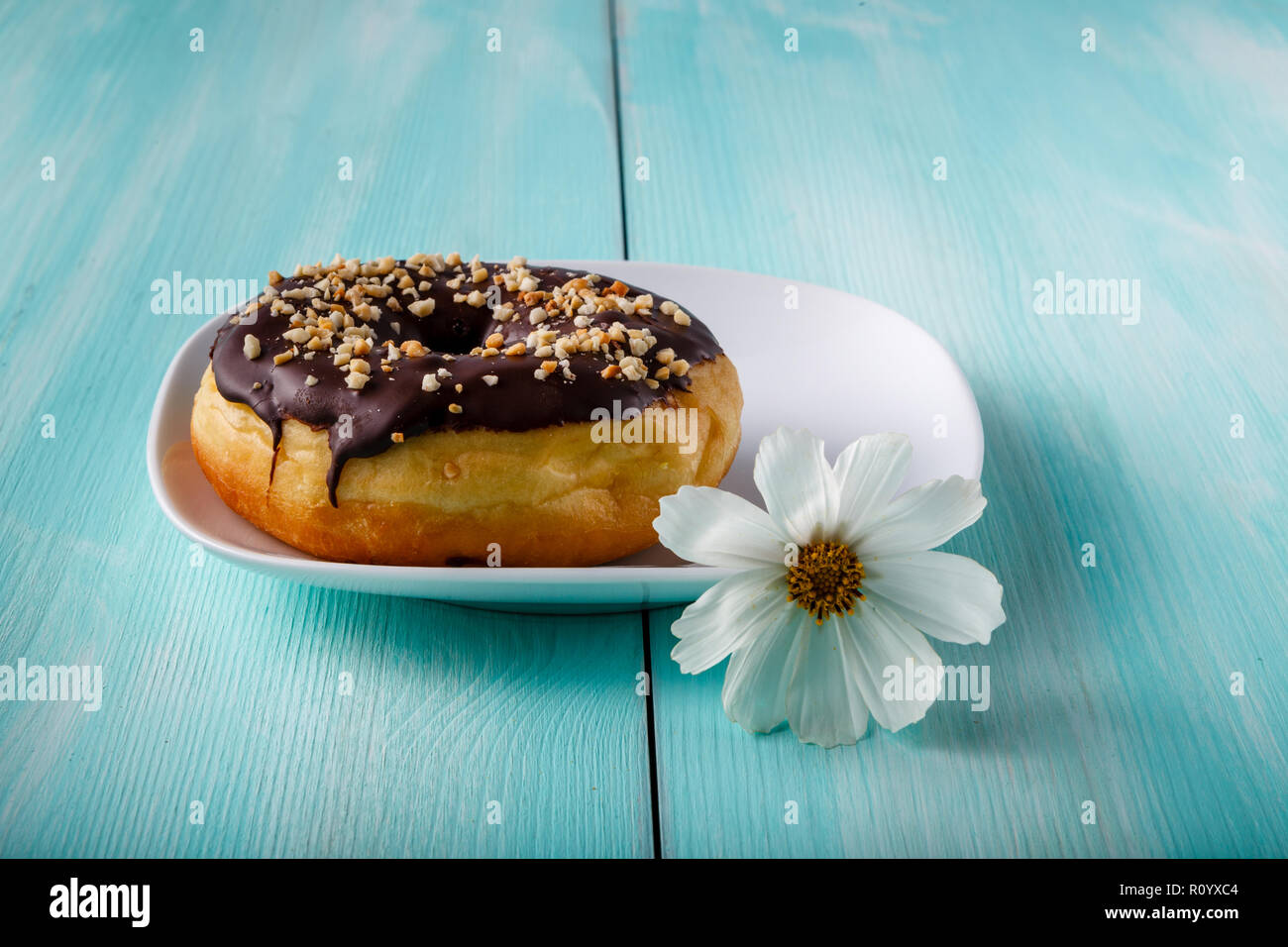 donuts on old wood table with flower Stock Photo