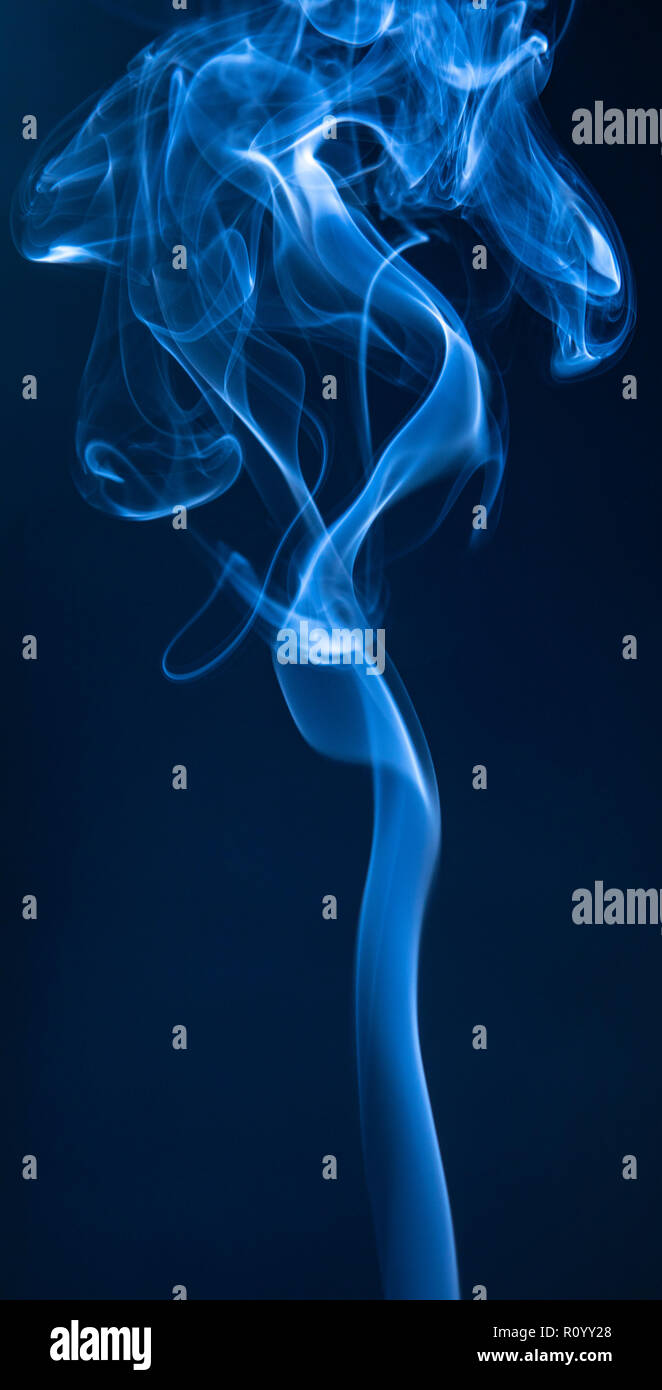 Abstract blue smoke swirls on dark background Stock Photo - Alamy