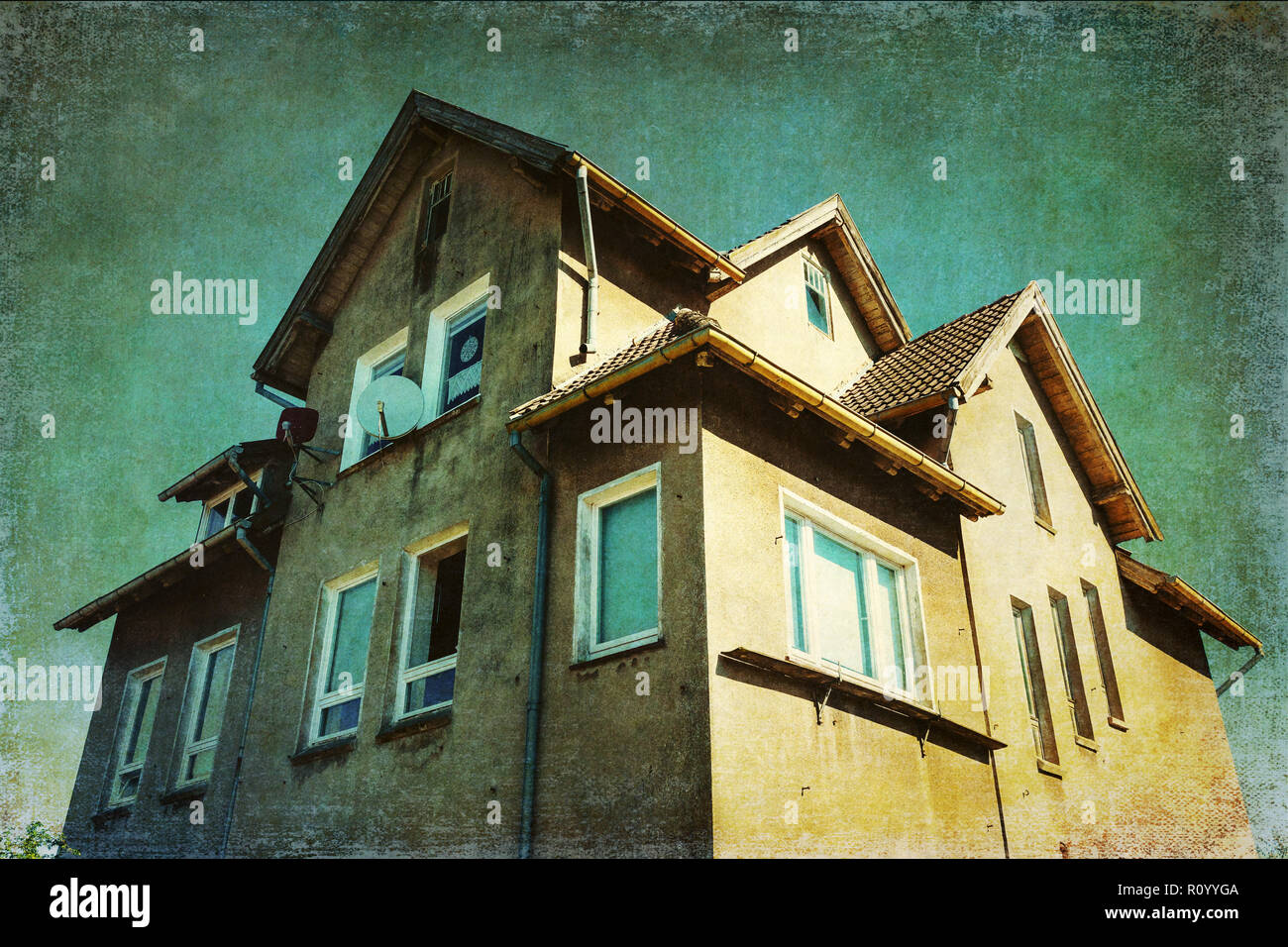 picture of an abandoned old one single family house with eerie looking texture Stock Photo