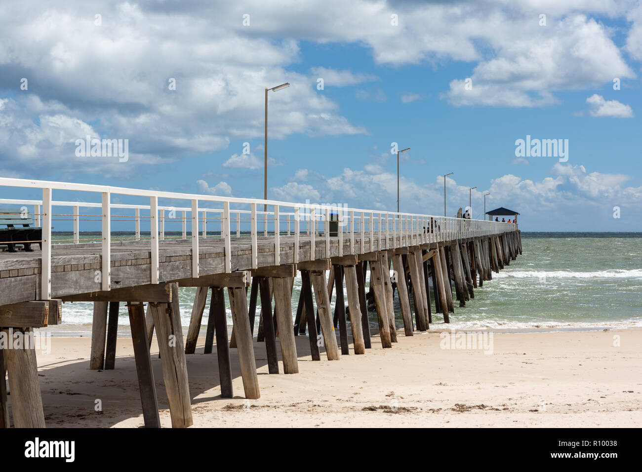The grange jetty with a blue sky and white fluffy clouds at Grange
