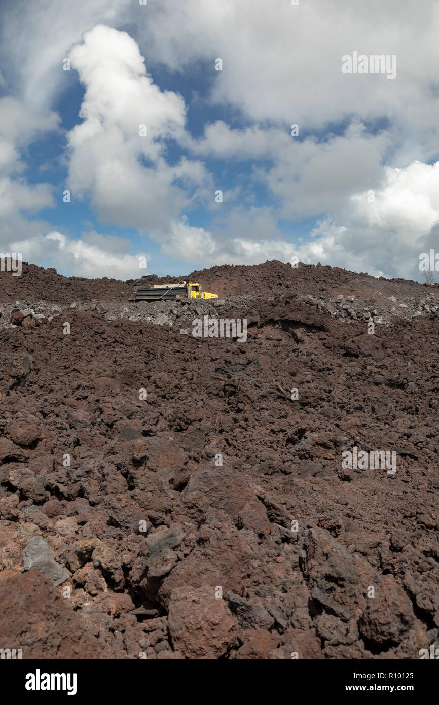 Pahoa, Hawaii Trucks traverse a road being built on cooled lava from the 2018 eruption of the